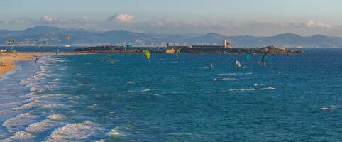 Aerial View of Tarifa's Coastline with Kite Surfers and Lighthouse photo