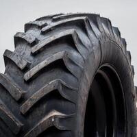 A close-up of a large tractor tire with detailed texture, showcasing its rugged tread pattern photo