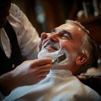 the barber is using a professional razor carefully gliding it along the client's jawline with precision and expertise photo