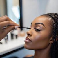 woman applying mascara photo