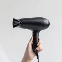 hair dryer in hand isolated on white photo