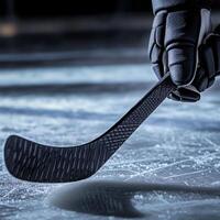 ice hockey player in action kicking with stick close up photo