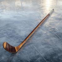 A full-length image of a classic wooden hockey stick standing upright on the ice rink photo