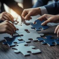 Hands holding puzzle. Teamwork concept. photo