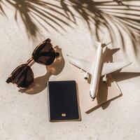 The concept of free travel. Top view of sunglasses, biometric passport and small airplane figurine photo