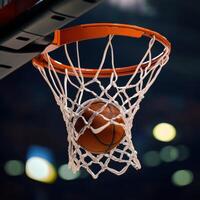 A basketball is in the net of a basketball hoop photo