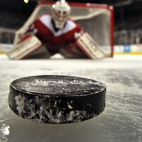 Ice hockey goalkeeper player on goal in action. An active game of hockey photo
