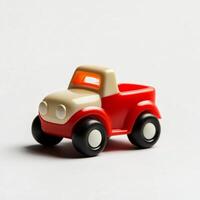 Red and white toy pickup truck standing on white background photo