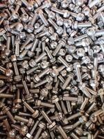 A close-up of stainless steel hex bolts and nuts in a shiny pile, showcasing durability, corrosion resistance, threading, and uniform design. Perfect for industrial, hardware, or engineering themes. photo