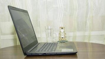 A laptop computer sitting on a table photo