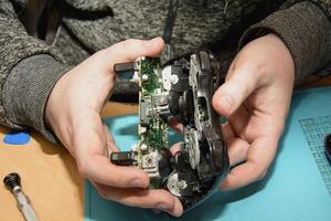A person is holding a game controller photo