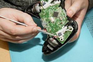 A person is working on a game controller photo