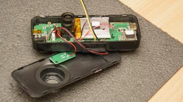 A small electronic device with wires and a battery photo