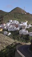 Aerial view of a small village on the slope of an old volcano on the island of Tenerife in the Spanish Canaries, vertical footage video