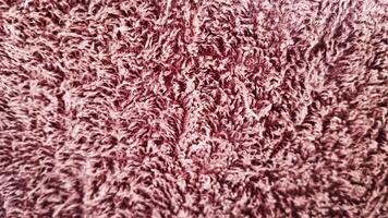 A close-up of plush, soft fabric with rich texture and vibrant color. Ideal for themes of comfort, luxury, and cozy home decor. photo