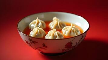 Dumplings placed in a decorative bowl with a vivid red backdrop, evoking warmth and cultural richness Generated by AI photo
