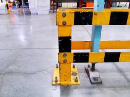 Yellow, black stainless steel pole or structure scratch and install on concrete floor in industrial for support big machine on top with copy space. photo
