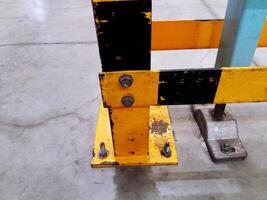 Yellow, black stainless steel pole or structure scratch and install on concrete floor in industrial for support big machine on top with copy space. photo