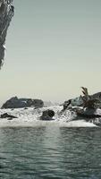 stone cliffs and sand at the ocean coastline video