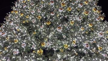 Christmas background, bright glowing lights with round balls on the New Year tree. Large background video