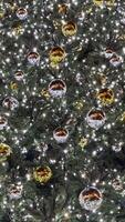 Christmas background, bright glowing lights with round balls on the New Year tree. Large background video