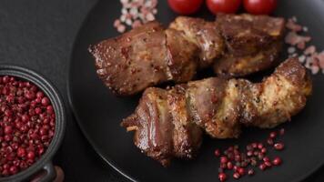 Delicious grilled chicken, turkey or pork skewers with salt, spices and herbs on a fire on a dark concrete background video