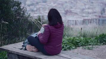 A woman leaves her village behind to climb to the lookout point and observe it from above. video