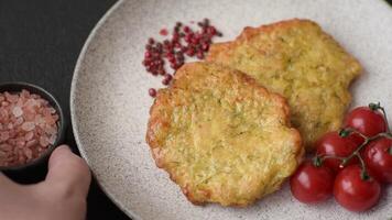Delicious fried pork or chicken chops breaded with salt and spices on a dark concrete background video