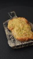Delicious fried pork or chicken chops breaded with salt and spices on a dark concrete background video