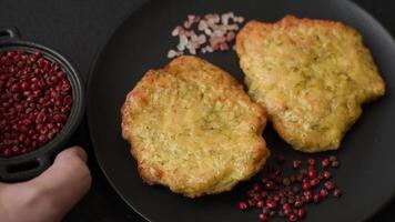 Delicious fried pork or chicken chops breaded with salt and spices on a dark concrete background video