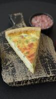 Delicious quiche with broccoli, cheese, chicken, spices and herbs on a dark concrete background video