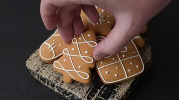 Delicious sweet gingerbread, madeleine biscuits and other elements of Christmas decorations on a dark concrete background video