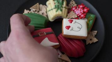 Sweet madeleine sponge cookies covered with colored chocolate in a Christmas style video