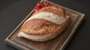 Homemade fresh crispy wholemeal bread on dark concrete background video