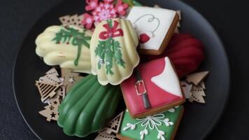 Sweet madeleine sponge cookies covered with colored chocolate in a Christmas style video