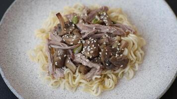 Rice noodles, asian food with soy sauce and spices on dark concrete background video