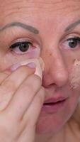 apply foundation woman applying cream foundation on face using one finger can be useful for creating natural look, helping foundation to melt. skin and making it easy to blend in sheer layer of makeup video
