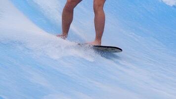 Close-up legs surfer balancing on surfboard. Water sports activity. Instructor demonstrating how to stand up on surfboard. The concept of practice and perseverance before it succeeds. Free copy space video