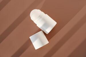 Roll-on deodorant on a purple background with shadow stripes. photo