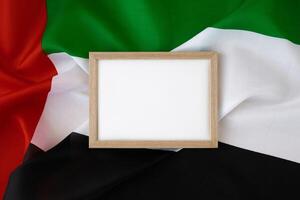 Empty white paper frame Small flag of UAE on beige background with colorful envelopes. Copy space. Mock up advertisement template. Tourism travel voucher with United Arab Emirates national symbol. Visit Dubai concept photo