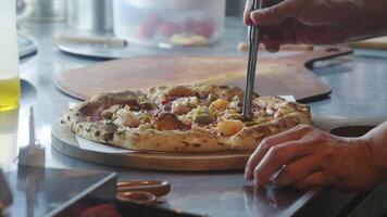 The chef is carefully arranging the toppings to create a delicious pizza. video