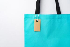 Eco bag for shopping with blank tag on white background photo
