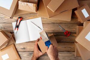 Packing products for delivery on wooden table, top view photo