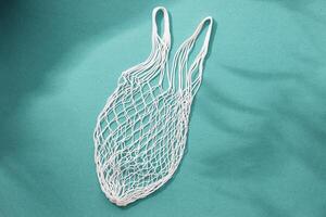 Empty string reusable bag on paper background, top view photo