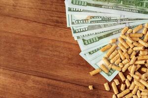 Dollar banknotes and wood pellets on wooden table photo