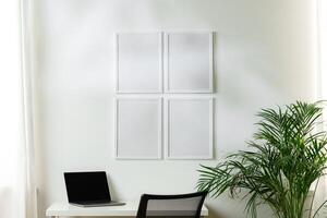 Empty frames on the wall above the working table in the office photo