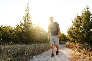 Portrait of hiker man with backpack trekking in the mountains photo