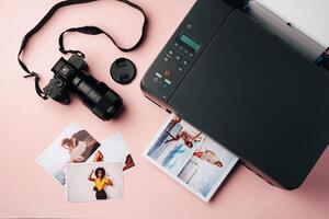 Printer and photo camera on table. Printing photos concept