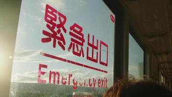 There is an 'emergency exit' sign on the window of a bus in Taipei City, Taiwan. video