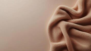 Soft, crumpled fabric in warm beige color on a neutral background showcasing texture and warmth in a cozy setting photo